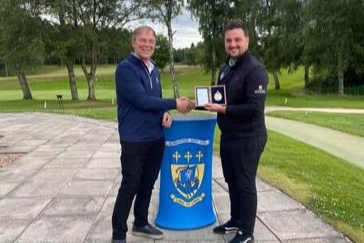 Three-time champion Connor Neil, right,  is congratulated by Blairgowrie  gents' captain Colin Allison. Picture: Blairgowrie GC