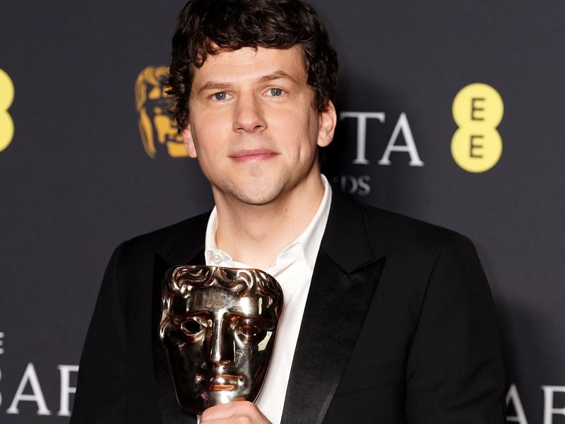 Jesse Eisenberg in the press room after winning the Best Original Screenplay award for A Real Pain during the 78th British Academy Film Awards