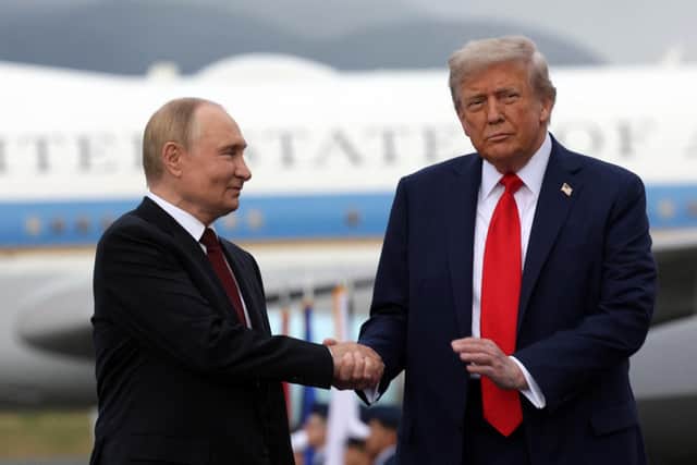US President Donald Trump and Russian President Vladimir Putin shake hands after their arrival for summit in Alaska (Picture: Gavriil Grigoriv/Pool/AFP via Getty Images)