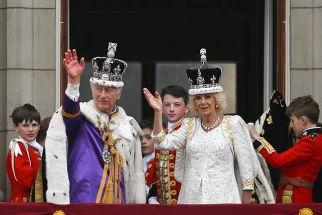 King Charles III and Queen Camilla wave from the Buckingham Palace balcony. Picture: Brandon Bell/Getty Images