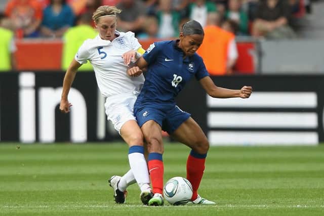 Faye White challenges Marie-Laure Delie of France during the FIFA Women's World Cup 2011 - one of four major tournament appearances for the former Lionesses captain (Photo by Christof Koepsel/Getty Images)