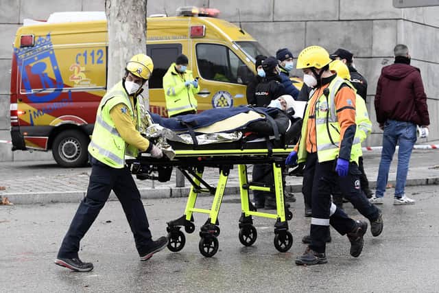 Emergency services take away an injured man on a stretcher after six floors collapsed on a building after a large explosion on Toledo Street in central Madrid on January 20, 2021 in Madrid, Spain (Photo by Carlos Alvarez/Getty Images).