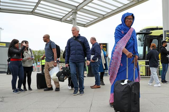 People evacuated from Sudan arrive on a flight from Cyprus into Stansted airport in Essex. Around 1,400 military personnel are involved in the "large-scale" evacuation of UK nationals after a three-day ceasefire was agreed.