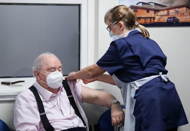 Ian Cormack receives the Oxford/AstraZeneca coronavirus vaccine, administered by practice nurse Ruth Davies, at Pentlands Medical Centre in Edinburgh (Picture: Russell Cheyne/PA)