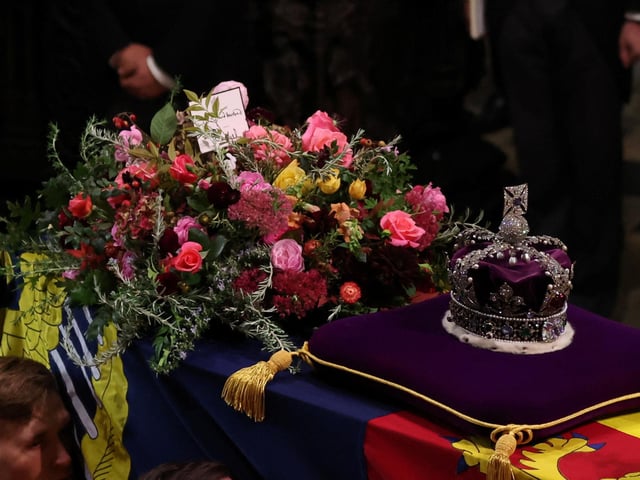 The coffin of Queen Elizabeth II with the Imperial State Crown and a message from King Charles III resting on top carried by the Bearer Party into Westminster Abbey the State Funeral of Queen Elizabeth II, held at Westminster Abbey, London. Picture date: Monday September 19, 2022.