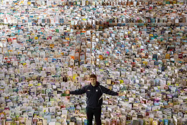 Captain Tom Moore's grandson Benjie, in the Great Hall of Bedford School, Bedfordshire, where over 120,000 birthday cards sent from around the world to celebrate Captain Tom's 100th birthday are being opened and displayed by staff.