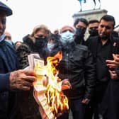 People burn their electricity bills as a protest against high energy prices in Turkey.