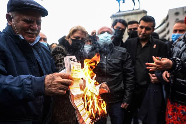 People burn their electricity bills as a protest against high energy prices in Turkey.