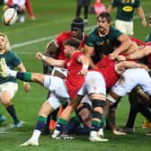 South Africa's scrum-half Faf de Klerk watches as Lions opposite number Ali Price clears the ball.
