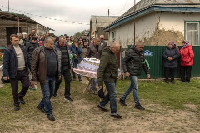 Men carry the coffin of eight-year-old Uliana Troichuk, killed during the Russian attack on a residential building in the village of Apolyanka, outside Uman, Ukraine.