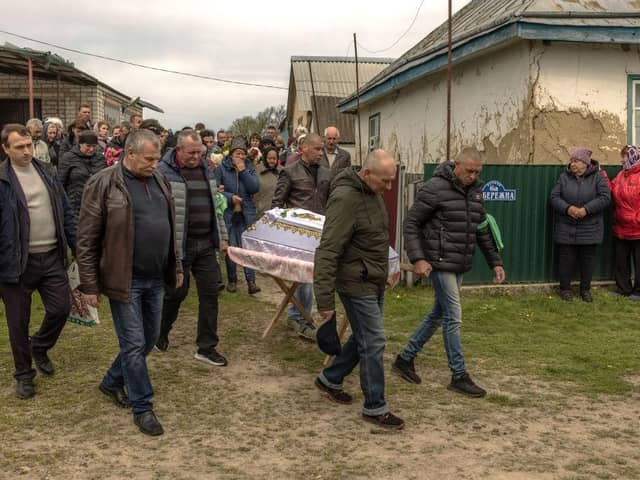 Men carry the coffin of eight-year-old Uliana Troichuk, killed during the Russian attack on a residential building in the village of Apolyanka, outside Uman, Ukraine.