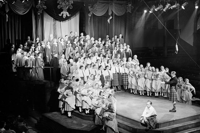 Members of the Newhaven Fisher Lassies Choir (among others) take part in  Edinburgh International Festival society production Hail Caledonia! in the Assembly Hall, in August 1954.