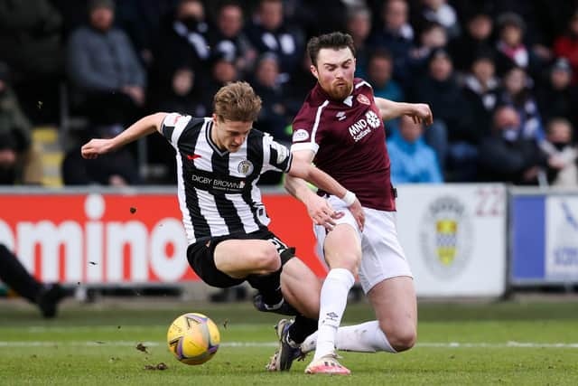 PAISLEY, SCOTLAND - FEBRUARY 26: Alex Greive (L) is tackled by John Souttar of Hearts during a Cinch Premiership match between St. Mirren and Hearts of Midlothian at SMiSA Stadium, on February 26, in Paisley, Scotland. (Photo by Alan Harvey / SNS Group)