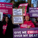 Campaigners hold placards in support of assisted dying in November last year in London. Photo by Carl Court/Getty Images