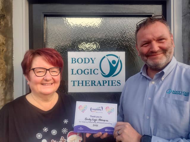 Sports Massage Therapist Jacquie Gibson and Duncan Thomson, Director of Body Logic Therapies accept their Respitality Donation Certificate from Quarriers for offering a therapy to local unpaid carer Jean Meikle
