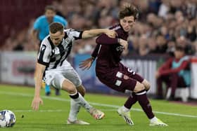 Hearts' Alex Lowry and PAOK's Tomasz Kedziora in action during the first leg at Tynecastle Park. (Photo by Mark Scates / SNS Group)