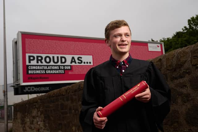 Social sciences graduate David Hughes from North Queensferry by a billbard in Meadowbank