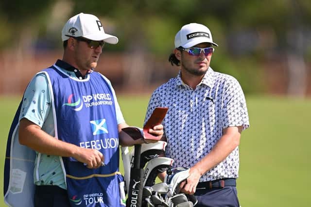 Ewen Ferguson chats to caddie Stephen Neilson during the second round at Jumeirah Golf Estates in Dubai. Picture: Ross Kinnaird/Getty Images.