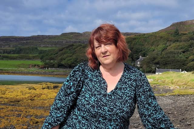 Fiona J Mackenzie on the shore in front of Canna House