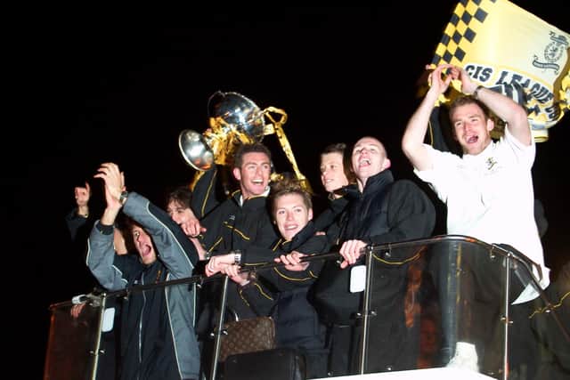 Livingston players celebrate their CIS Cup win on an open top bus in March 2004. They had beaten Hibs 2-0 to win their only major trophy to date