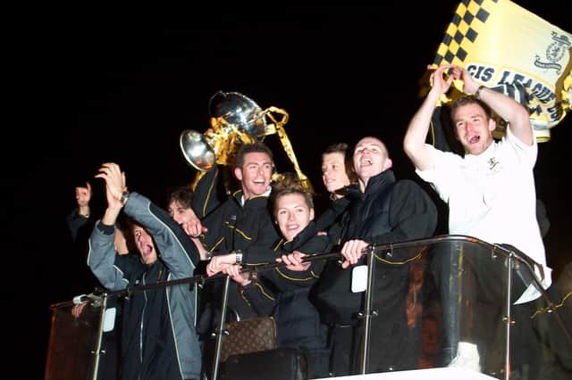 Livingston players celebrate their CIS Cup win on an open top bus in March 2004. They had beaten Hibs 2-0 to win their only major trophy to date