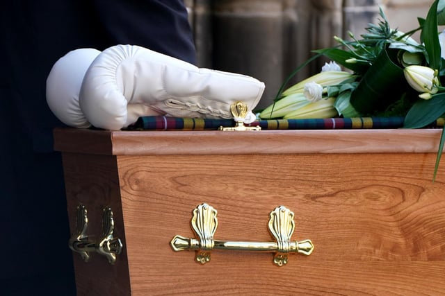 A pair of white boxing gloves rest on the coffin of former boxer Ken Buchanan at St Giles' Cathedral, Edinburgh, ahead of a memorial service.