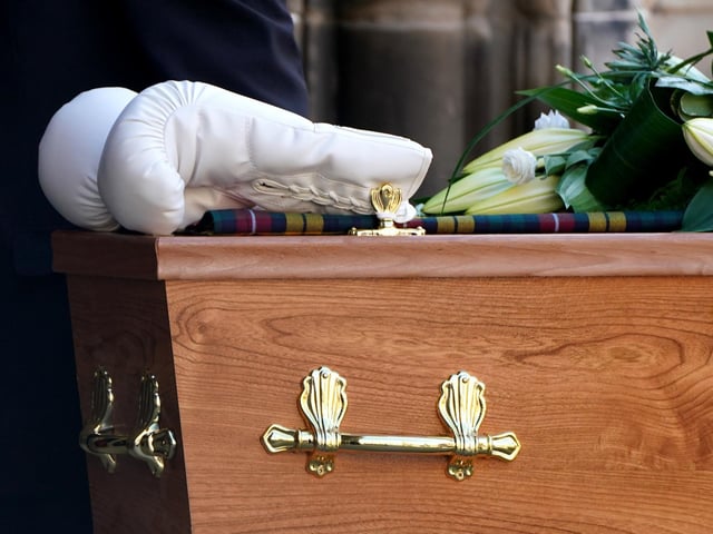A pair of white boxing gloves rest on the coffin of former boxer Ken Buchanan at St Giles' Cathedral, Edinburgh, ahead of a memorial service.
