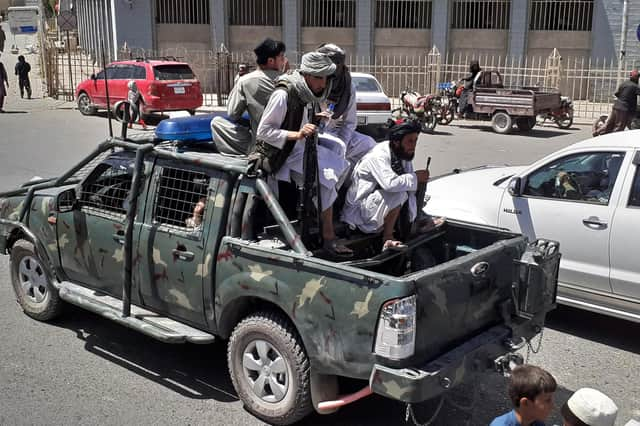 Taliban fighters on a street in the newly occupied city of Kandahar on Friday (Picture: AFP via Getty Images)