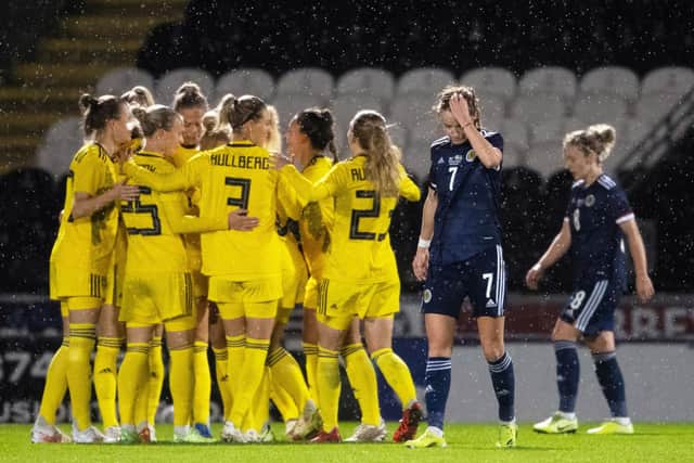 Scotland's Christy Grimshaw looks dejected as Sweden celebrate their opener. Picture: SNS
