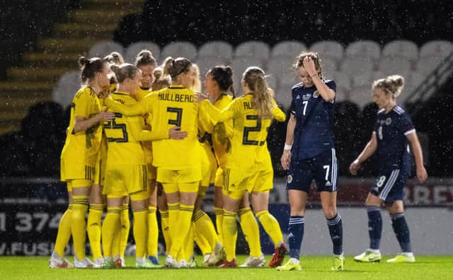 Scotland's Christy Grimshaw looks dejected as Sweden celebrate their opener. Picture: SNS