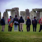 People view the stones during Summer Solstice at Stonehenge, where some people jumped over the fence to enter the stone-circle to watch the sun rise at dawn of the longest day in the UK.