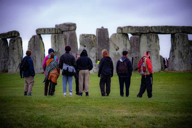 People view the stones during Summer Solstice at Stonehenge, where some people jumped over the fence to enter the stone-circle to watch the sun rise at dawn of the longest day in the UK.