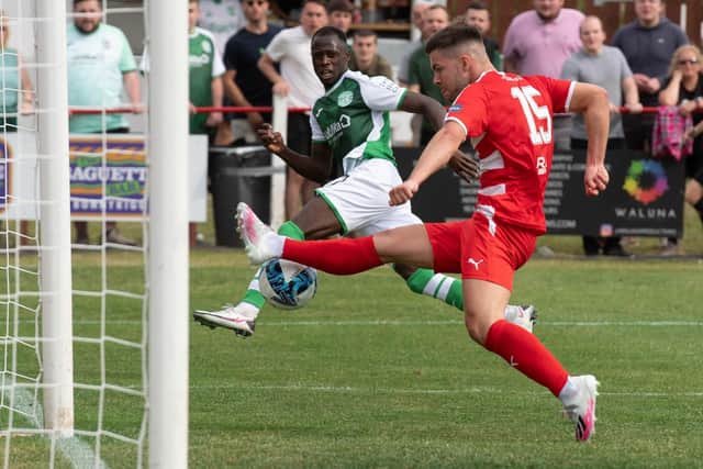 Hibs' Momodou Bojang has a shot cleared off the line on his debut.
