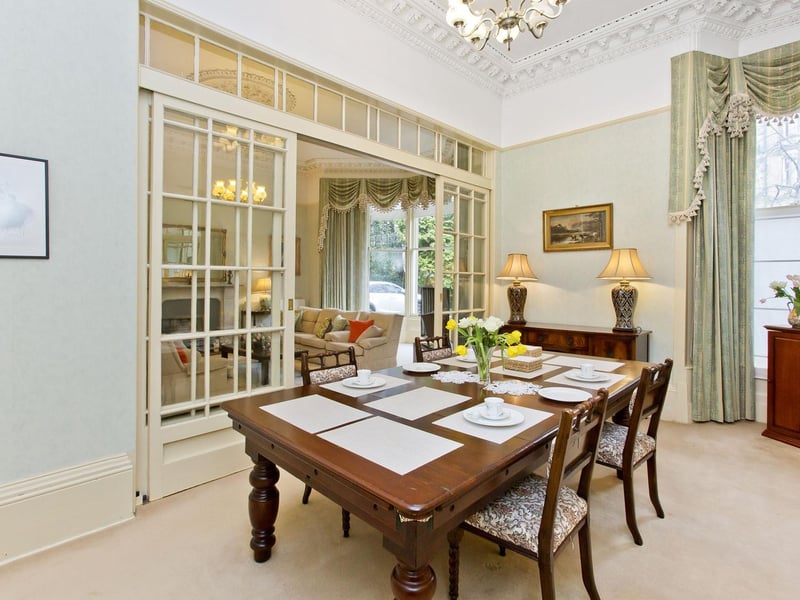 The formal adjoining dining room easily sits six people.