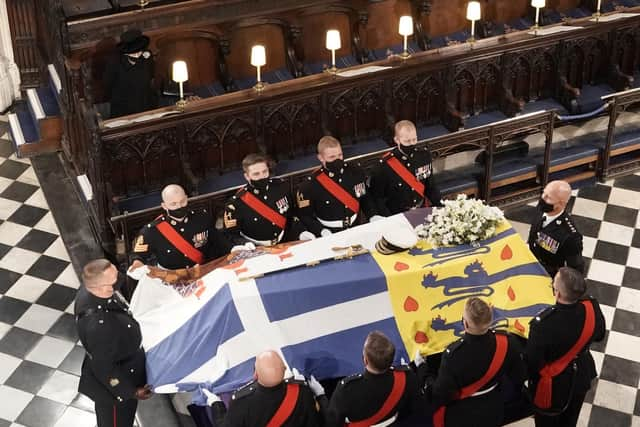 Her Majesty watches as the coffin of the Duke of Edinburgh is placed St George's Chapel