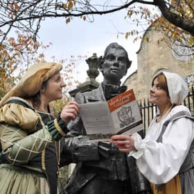 A statue of Robert Fergusson stands outside the Canongate Kirk