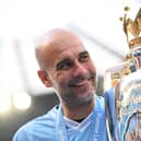 Manchester City manager Pep Guardiola poses for a photo with the Premier League trophy. (Photo by Michael Regan/Getty Images)