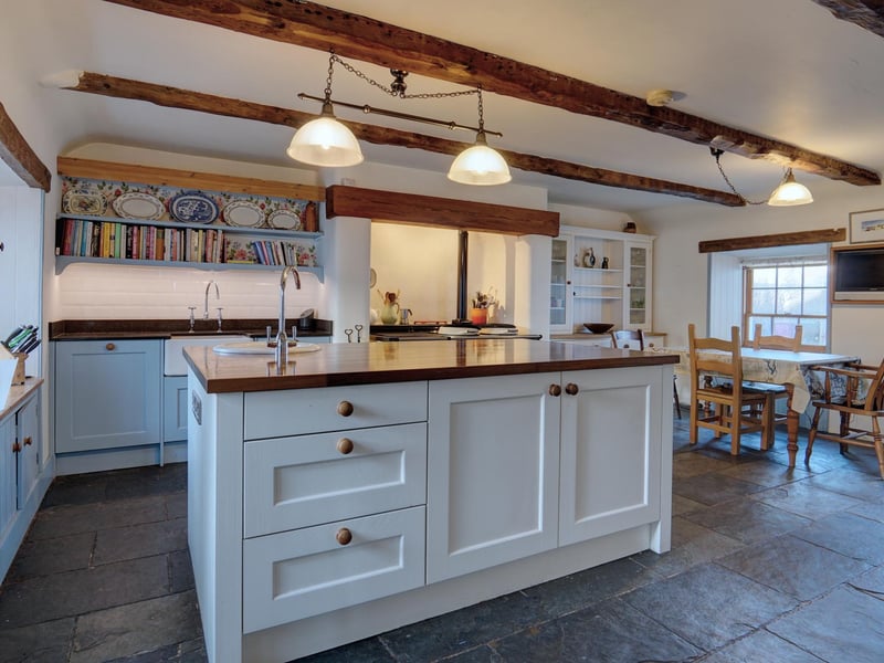 Interior: The accommodation includes a sitting-dining room with wood-burning stove, a snug, family room with timber beams, and a contemporary dining/kitchen with an Aga.range.