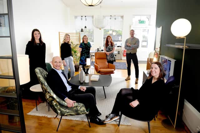 Julian Darwell-Stone, seated front, with Sarah Ramsay, managing director, seated front, and members of the team in Tangram Furnishers' Edinburgh showroom. Picture: Colin Hattersley