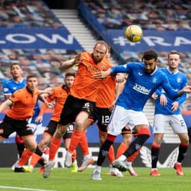 Dundee United's Mark Reynolds (L) wins a header against Connor Goldson during a Scottish Premiership match between Rangers and Dundee United at Ibrox Stadium, on September 12, 2020, in Glasgow, Scotland. (Photo by Alan Harvey / SNS Group)