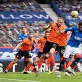 Dundee United's Mark Reynolds (L) wins a header against Connor Goldson during a Scottish Premiership match between Rangers and Dundee United at Ibrox Stadium, on September 12, 2020, in Glasgow, Scotland. (Photo by Alan Harvey / SNS Group)