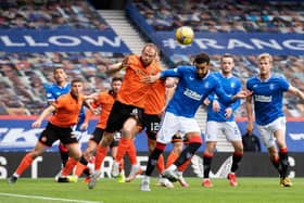 Dundee United's Mark Reynolds (L) wins a header against Connor Goldson during a Scottish Premiership match between Rangers and Dundee United at Ibrox Stadium, on September 12, 2020, in Glasgow, Scotland. (Photo by Alan Harvey / SNS Group)