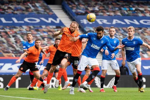 Dundee United's Mark Reynolds (L) wins a header against Connor Goldson during a Scottish Premiership match between Rangers and Dundee United at Ibrox Stadium, on September 12, 2020, in Glasgow, Scotland. (Photo by Alan Harvey / SNS Group)