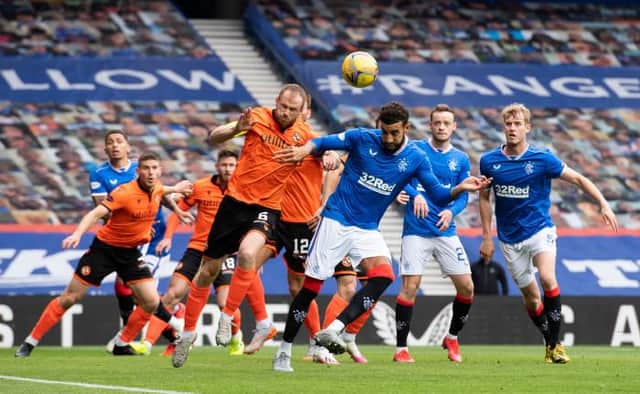 Dundee United's Mark Reynolds (L) wins a header against Connor Goldson during a Scottish Premiership match between Rangers and Dundee United at Ibrox Stadium, on September 12, 2020, in Glasgow, Scotland. (Photo by Alan Harvey / SNS Group)