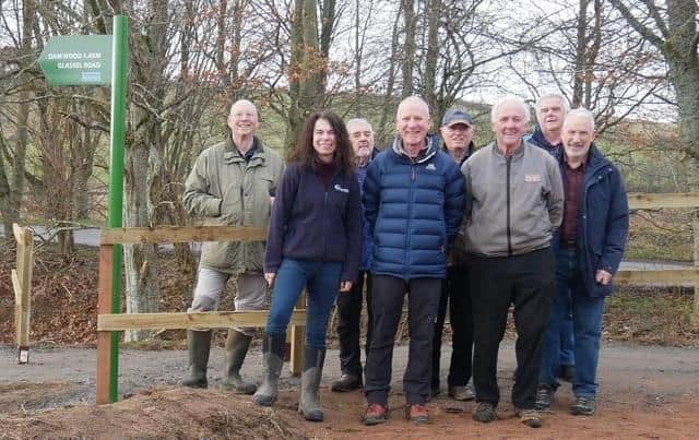 Will Maclean, Chair of the Torphins Paths Group front centre, Dr Susan Cooksley, Manager of the Dee Catchment Partnership front left, Bert McIntosh, McIntosh Plant Hire (Abdn) Ltd front right, with TPG Volunteers behind, celebrate the newly-opened path by the Easter Beltie burn.