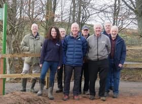Will Maclean, Chair of the Torphins Paths Group front centre, Dr Susan Cooksley, Manager of the Dee Catchment Partnership front left, Bert McIntosh, McIntosh Plant Hire (Abdn) Ltd front right, with TPG Volunteers behind, celebrate the newly-opened path by the Easter Beltie burn.