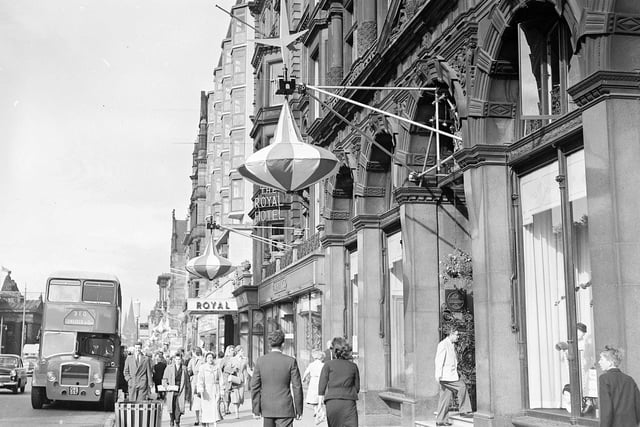 Here, you can see lantern style Edinburgh Festival decorations that have been hung up outside of Jenners on Princes Street. Year: 1957