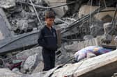 A Palestinian boy stands amidst the rubble of a building following Israeli strikes in Rafah in the southern Gaza Strip on November 22, 2023, amid ongoing battles between Israel and the Palestinian militant group Hamas. (Photo by SAID KHATIB / AFP) (Photo by SAID KHATIB/AFP via Getty Images)