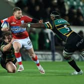 Finn Russell of Racing 92 is tackled by Api Ratuniyarawa (R) and Nick Auterac during the Heineken Champions Cup win over Northampton Saints. (Photo by David Rogers/Getty Images)