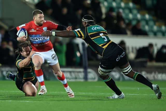 Finn Russell of Racing 92 is tackled by Api Ratuniyarawa (R) and Nick Auterac during the Heineken Champions Cup win over Northampton Saints. (Photo by David Rogers/Getty Images)